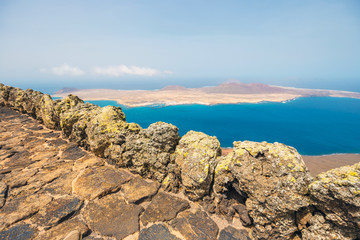 Fototapeta na wymiar Impressive view from Mirador del Rio to island of La Graciosa, Lanzarote, Canary islands