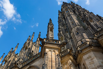 Fototapeta na wymiar Closeup view on gothic cathedral of St. Vitus with blue sky in Prague Castle, Prague, Czech Republic
