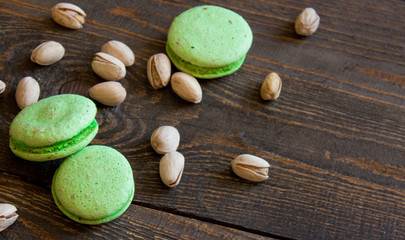 Pistachio macaroons on a wooden table