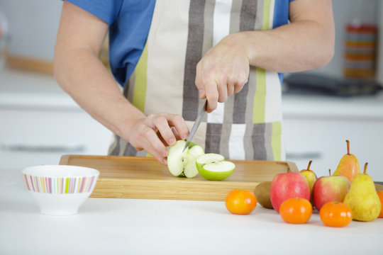 Closeup of man chopping fruit