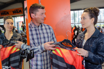 Woman in shop looking at reflective motorcycle clothing