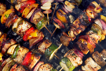 Grilled skewers on a grilled plate, top view