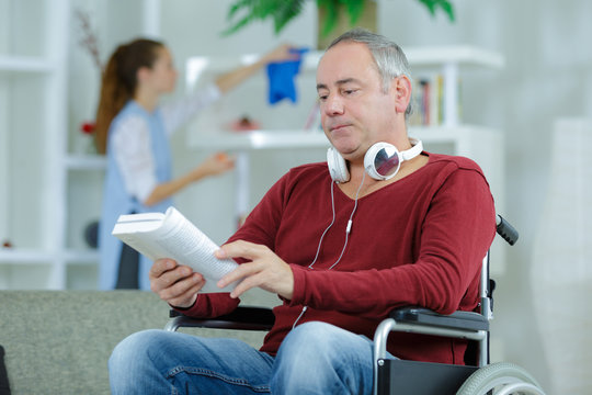 Man in wheelchair reading book