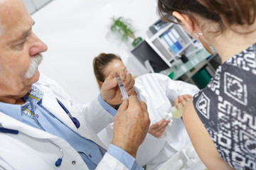Doctor preparing injection for patient