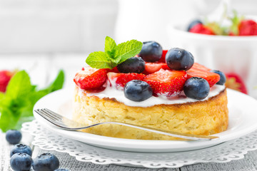 Delicious berry cheesecake with fresh strawberry and blueberry on white background