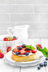 Delicious berry cheesecake with fresh strawberry and blueberry on white background