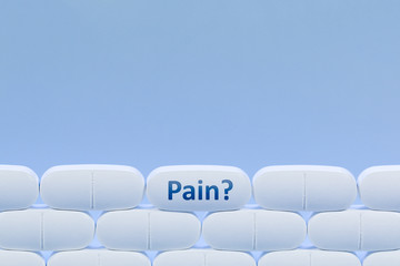 Rows of white pills on a blue background with the word 'Pain'
