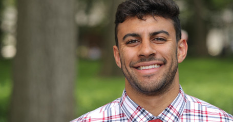 Young man in city park face portrait