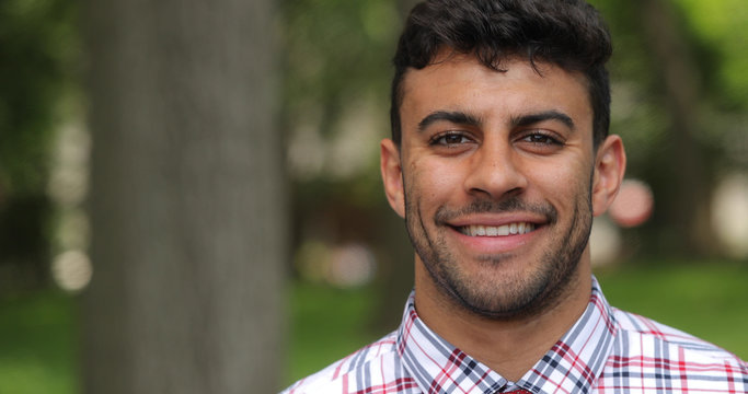 Young man in city park face portrait