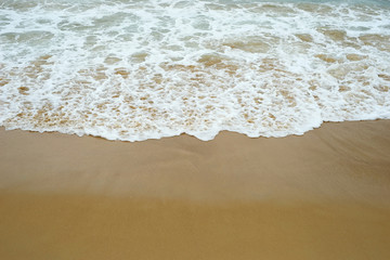 Fototapeta na wymiar ocean beach with wave and sand