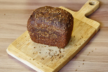 A loaf of rye bread on a wooden board