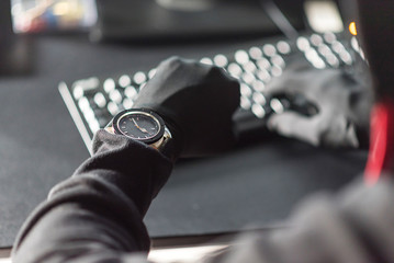 Hand of hacker with modern watch