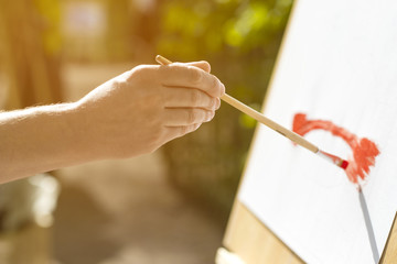 Hand of an artist beginning to paint