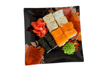  Sushi rolls with raw salmon.Traditional japanese food..Philadelphia Sushi on a black plate close-up