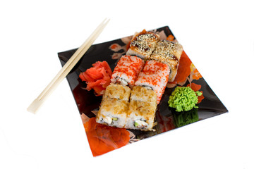  Sushi rolls with raw salmon.Traditional japanese food..Philadelphia Sushi on a black plate close-up