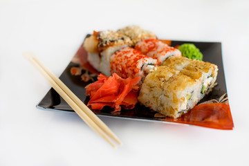  Sushi rolls with raw salmon.Traditional japanese food..Philadelphia Sushi on a black plate close-up