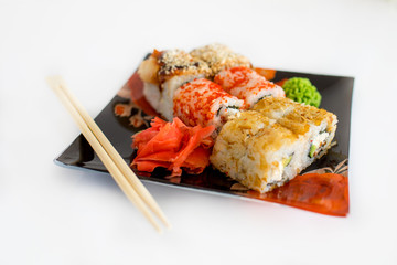  Sushi rolls with raw salmon.Traditional japanese food..Philadelphia Sushi on a black plate close-up
