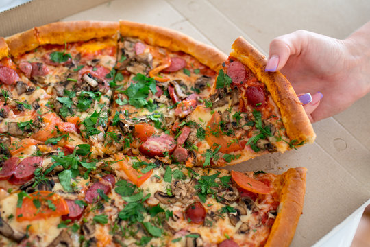 The Girl Takes A Slice Of Pizza Out Of The Box