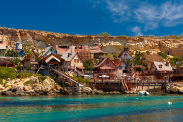 Traditional colorful houses in the famous Popeye Village at Anchor Bay, Il-Mellieha, Malta