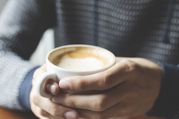 close-up of young man eating breakfast coffee