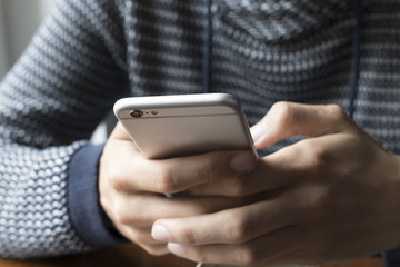 young man with mobile phone indoor