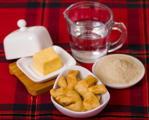 Delicious ecuadorian pristinos piled up in bowl, traditional andean pastry, cheese platter and coffee cup sitting besides