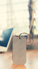 Brown paper tag on wooden table- vintage color effect