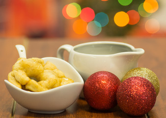 Delicious ecuadorian pristinos piled up in bowl, traditional andean pastry, fruit platter and coffee cup sitting besides