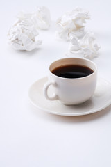 Working with crumpled paper and coffee cup on table background