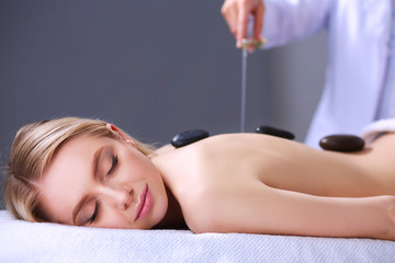 Young woman lying on a massage table,relaxing with eyes closed