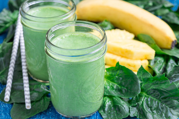Detox green smoothie with spinach, pineapple, banana and yogurt, horizontal
