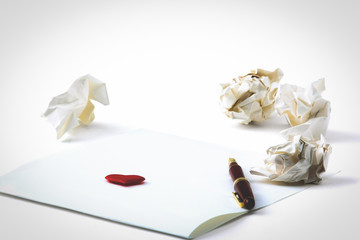 Working with crumpled paper and gift card with heart on table background