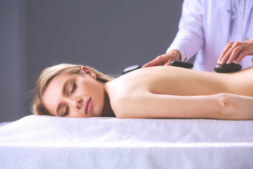 Young woman lying on a massage table,relaxing with eyes closed