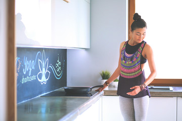 Fit and attractive young woman preparing healthy meal