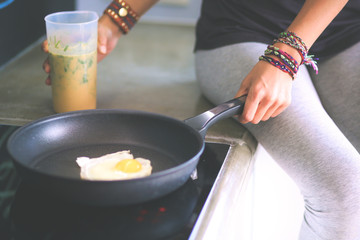Fitness girl cooking healthy food in the kitchen