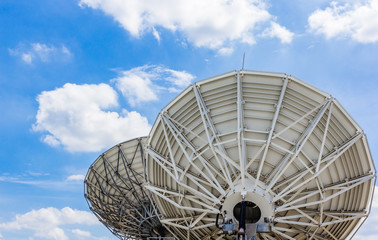 picture of parabolic satellite dish space technology receivers under blue sky