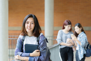 Portrait cute asian student college with teenager student background. Education concept.