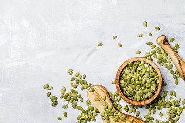Raw pumpkin seeds, food background, top view