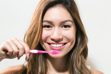 Happy woman holding a toothbrush