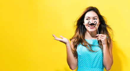  Young woman holding paper party sticks