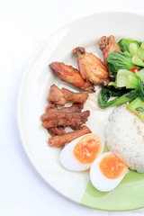 stir fried vegetables, Hard-boiled egg, Fried pork and Fried chicken wings with thai jasmine rice on dish. Thai food.
