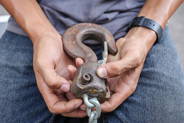 Close-up of male hands and lifting hook horizontal