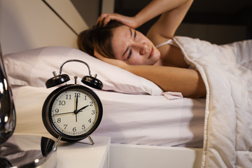 clock show 2 O'clock and woman sleepless on bed