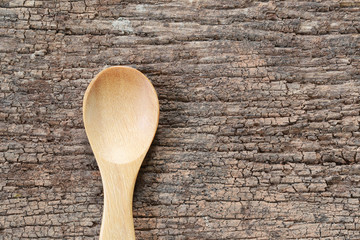 Empty wooden spoon on wood floor.