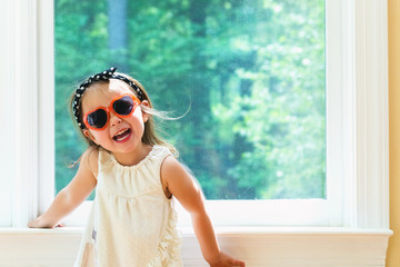 Happy toddler girl wearing sunglasses