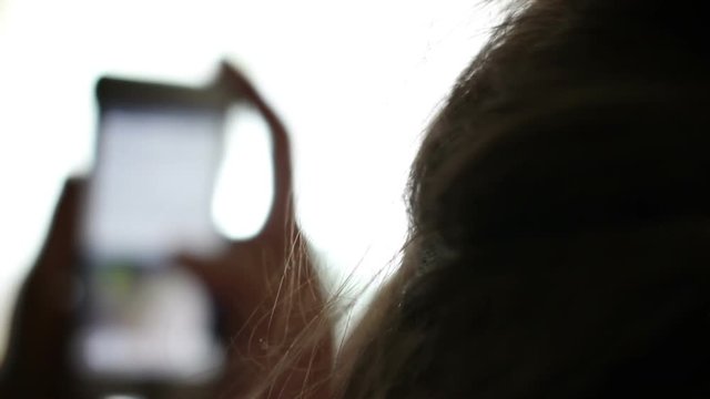 Mother spying on her childs social media profile through her smartphone