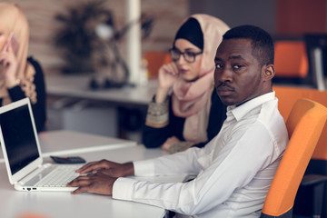 Multiracial contemporary business people working connected with technological devices