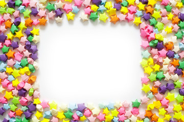 Fototapeta premium Colorful folded paper star or origami lucky star to use as frame.
