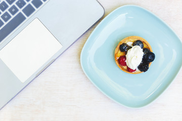 Overhead view of laptop and desserts