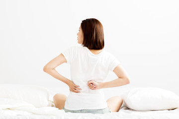 woman have  backache on white bed  in morning.